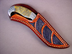 "Iraca" sheathed view. Note sheath is protective of blade and cutting edge, yet displays handle and bolster embellishment. "Iraca" sheathed view. Note sheath is protective of blade and cutting edge, yet displays handle and bolster embellishment.